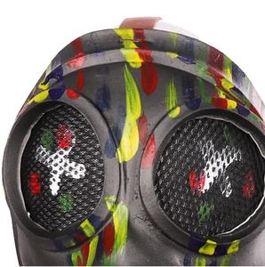 Close-up of steampunk gas mask with colorful paint splatter and leather strap detail
