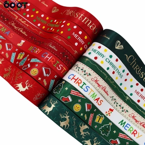 Close-up of festive grosgrain ribbons with Merry Christmas gold foil prints and elk patterns