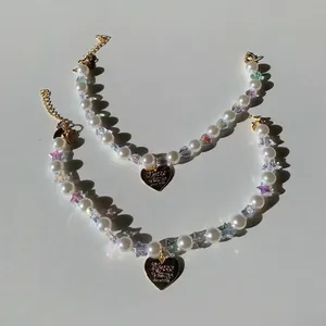 Elegant pearl pet necklace with golden heart pendant and sparkling star charms