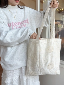 French style white lace embroidered canvas tote bag for women shown in lifestyle setting