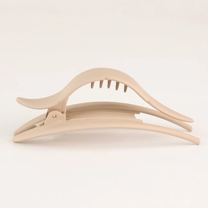 Close-up of beige matte hair claw clip showing durable spring and anti-slip teeth design