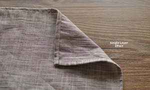 Close-up of linen napkin with brown stripes showing fine weave texture and single layer detail
