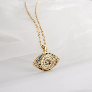 Macro detail of gold evil eye pendant with multicolored gemstones on an O-chain link