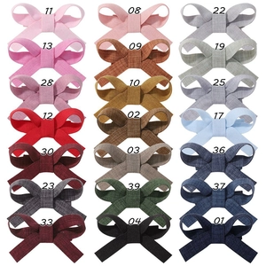 Close-up of 21 colorful linen fabric bow hair clips with numbered color selection guide