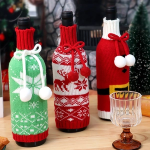 Three festive Christmas knitted wine bottle covers with reindeer and snowflake patterns