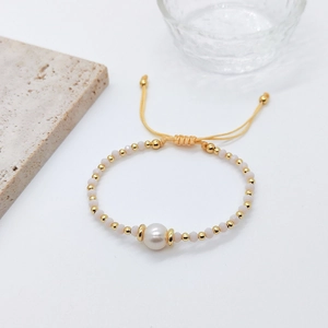 Ethnic layered pearl bracelet with colorful ceramic beads and yellow woven rope