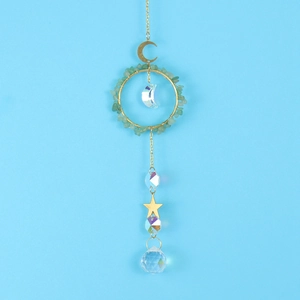 Detail of crystal suncatcher with green aventurine ring and moon star pendants