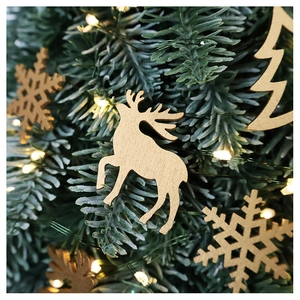 Detail of wooden reindeer and snowflake ornaments on a lit Christmas tree branch
