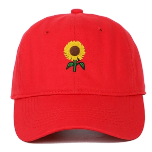 Close-up of vibrant sunflower embroidery on a red soft-top baseball cap for outdoors