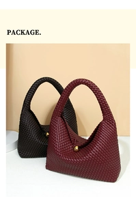 Detail of woven crescent bags in burgundy and dark brown with golden ball clasps