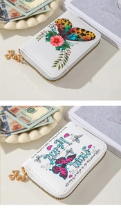 Detail of white PU leather wallet with butterfly floral print and clover zipper pull
