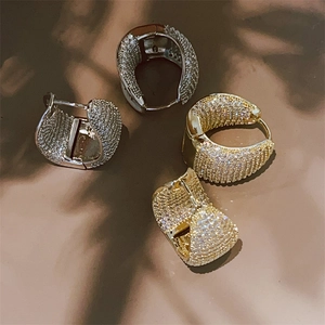 Luxe paved zircon hoop earrings in gold and silver finish with hinged closure design