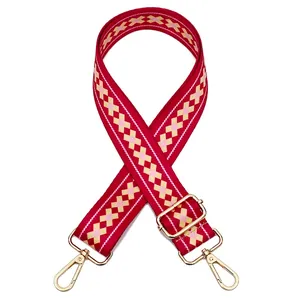 Adjustable red geometric woven shoulder strap with gold metal buckles and lobster clasps