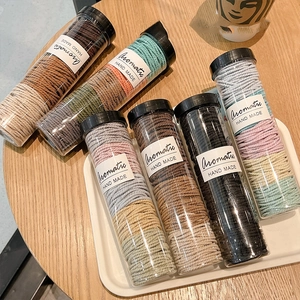 Assorted high-elastic hair ties in transparent jars, featuring multi-color braided designs