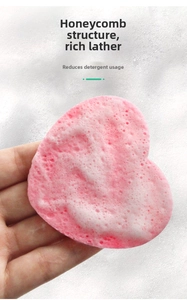 Macro shot of heart-shaped pink cellulose sponge creating rich foam for cleansing