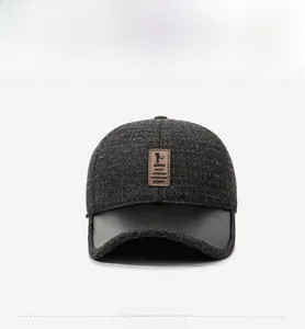 Detailed view of winter baseball cap with gray knit texture and black leather brim