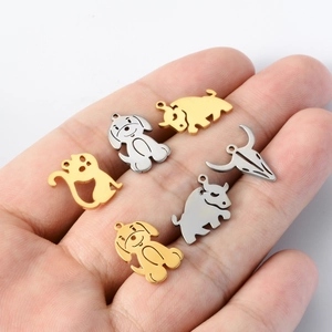 Cute stainless steel animal pendants for DIY jewelry shown on a hand for scale