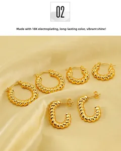 Macro detail of gold plated twisted hoop earrings on elegant champagne silk fabric