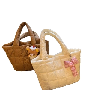 Quilted tote bags in caramel brown and cream white with cute plush pendants