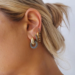 Detailed view of S925 silver gold-plated hoop earrings with vibrant blue gemstones