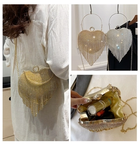 Three-way view of heart evening bag with crystal tassels, chain strap, and inner storage