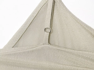 Detail view of champagne textured fabric strap with silver adjustable metal ring