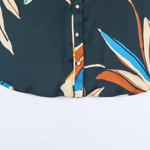 Women's casual floral print shirt featuring abstract leaves and button-down curved hem