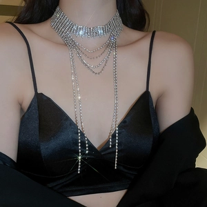 Close-up of layered silver fringe necklace with sparkling rhinestones on a model