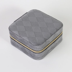 Gray quilted velvet jewelry box with square design and golden metal zipper detail