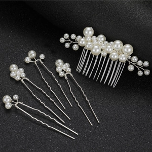 Detailed set of bridal hair accessories featuring white pearls and silver wire on black