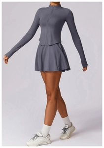 Détail d'un ensemble de tennis gris foncé séchage rapide avec veste zippée et jupe plissée