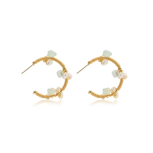 Handmade gold drop earrings with green natural stones and white pearls on white background