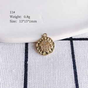 Detailed view of a gold Hamsa hand pendant with crystal inlay and 13x15x1mm dimensions