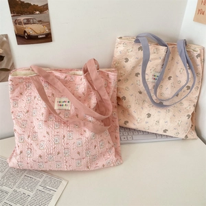 Close-up of quilted tote bags featuring cute animal embroidery in pink and beige