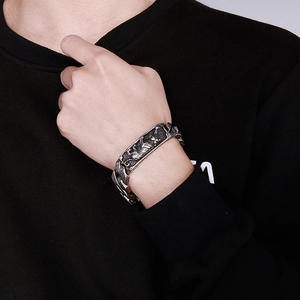 Detailed view of retro tiger relief carving on vintage stainless steel men's bracelet