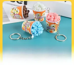 Detailed view of colorful mini popcorn bucket keychains for bags and key decoration