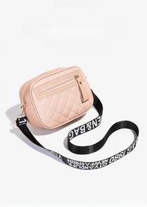 Close-up of pink quilted PU leather bag with gold hardware and wide letter strap