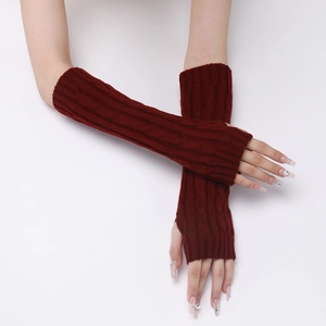 Detailed knit texture of burgundy fingerless gloves with elegant cable patterns