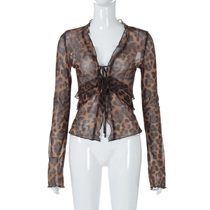 Close-up of leopard print sheer mesh fabric with ruffle trim and tie-front closure details