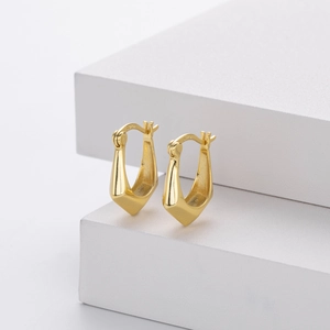 Close-up of golden S925 sterling silver hoop earrings showing the authentic metal hallmark
