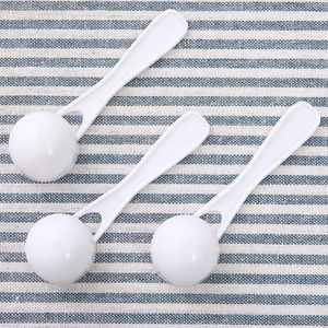 Set of three white plastic measuring spoons with round base for milk powder and spices