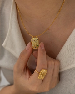 Detail showing snake relief pendant and ring set with colorful zircon and gold plating