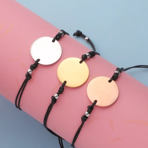 Three minimalist woven bracelets with adjustable black wax cord and circular metal charms