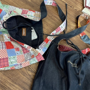 Detail of vintage denim tote bag showing colorful patterned strap and interior leather pocket