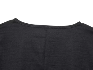 Close-up of the round neckline and precise stitching on the black woven fabric