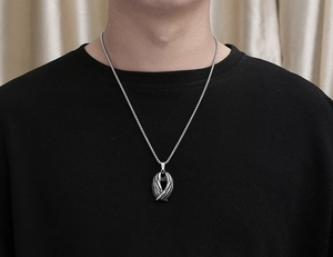 Vue détaillée du pendentif ailes argentées avec chaîne box portée par un mannequin