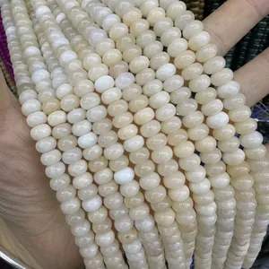 Detail of cream natural stone abacus beads showing smooth texture and translucent finish