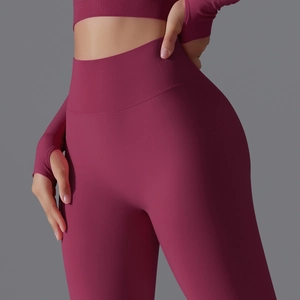 Close-up of seamless high-waist ribbed yoga set in dark red with peach lift sculpting effect