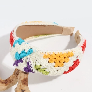 Detailed view of handmade crochet headband featuring colorful floral patchwork patterns
