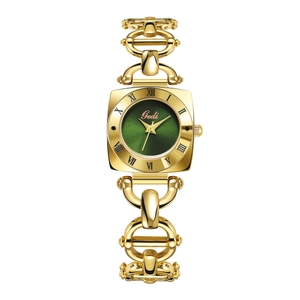 Detailed macro view of a vintage gold bracelet watch with a green square dial